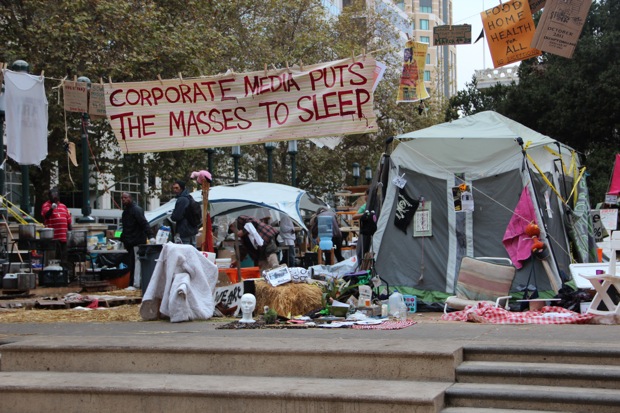 “corporate media puts the masses to sleep” banner at early occupy oakland circa october